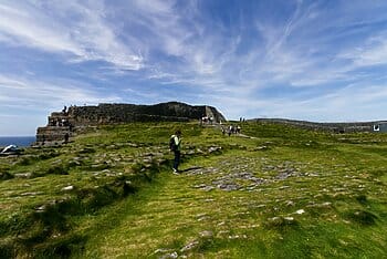 Woman on mountain with group behind her for Wonder Voyage blog post about Ireland pilgrimage tour