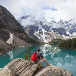 image of man on mountain with hiking back pack for blog about using AI for trip planning