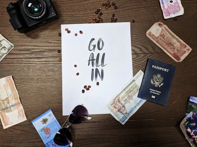 9 Trusted Mission Trip Prep Strategies (Plus a FREE Resource) image of passport, camera, and sign that says "go all in" for Wonder Voyage blog post about mission trip prep