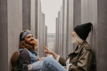 man listens to woman tell a story for blog post about mission trip prep