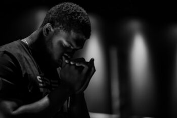 man praying with lights behind him for blog post about mission trip prep