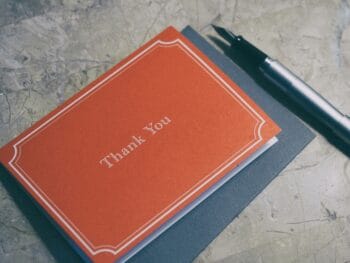 red thank you note with pen
