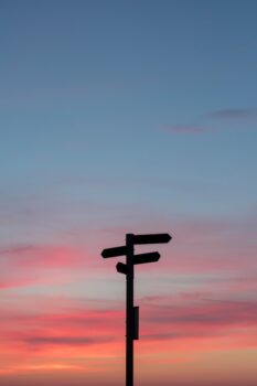 wooden trail sign at sunset for Wonder Voyage post about how to plan your 2027 pilgrimage
